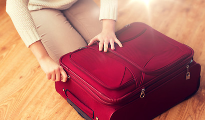 Image showing close up of woman packing travel bag for vacation