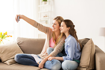 Image showing happy family taking selfie by smartphone at home