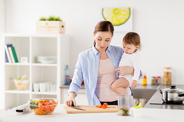 Image showing happy mother and baby cooking food at home kitchen