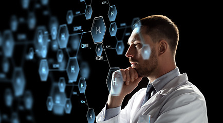 Image showing scientist looking at chemical formula projection