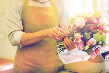 Image showing close up of man making bunch at flower shop