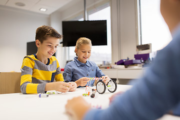 Image showing happy children building robots at robotics school