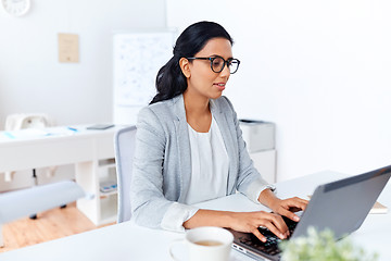 Image showing businesswoman with laptop working at office