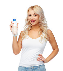 Image showing happy beautiful young woman with bottle of water