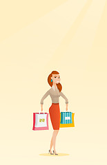 Image showing Young happy caucasian woman with shopping bags.