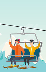 Image showing Two caucasian skiers using cableway at ski resort.