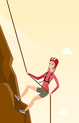 Image showing Caucasian woman climbing a mountain with rope.
