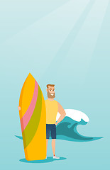 Image showing Young caucasian surfer holding a surfboard.