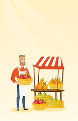 Image showing Greengrocer holding box full of apples.