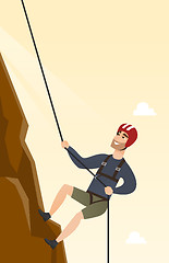 Image showing Young caucasian man climbing a mountain with rope.