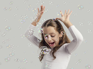 Image showing Girl playing with soap bubbles