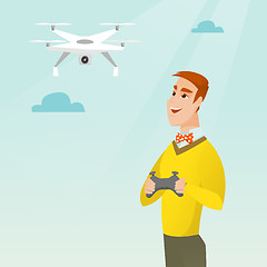 Image showing Young caucasian man flying drone.