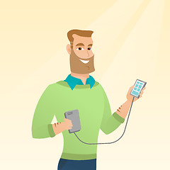 Image showing Man reharging smartphone from portable battery.