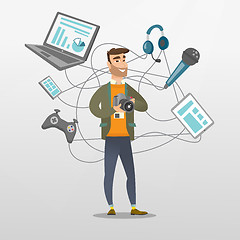 Image showing Young caucasian man surrounded by her gadgets.