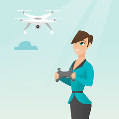 Image showing Young caucasian woman flying drone.