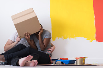 Image showing young multiethnic couple playing with cardboard boxes