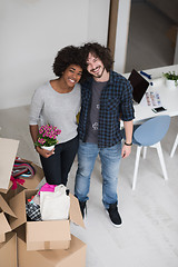 Image showing multiethnic couple moving into a new home