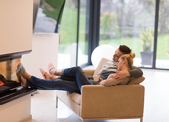 Image showing Young couple  in front of fireplace