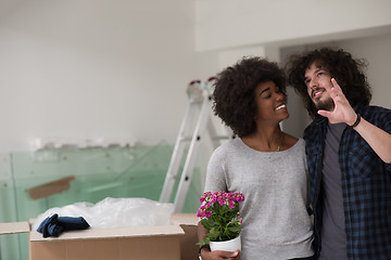 Image showing multiethnic couple moving into a new home