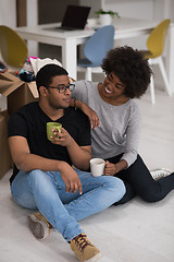 Image showing African American couple relaxing in new house