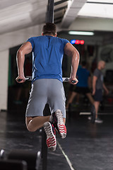 Image showing man doing exercises parallel bars