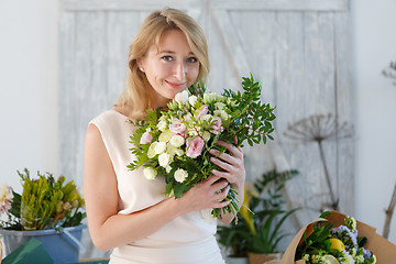 Image showing Beautiful blonde in flower shop