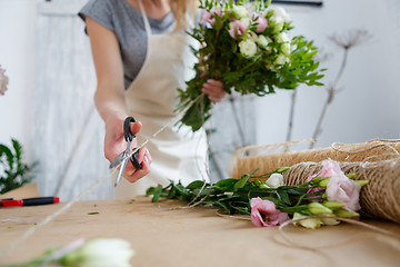 Image showing Girl florist makes beautiful bouquet