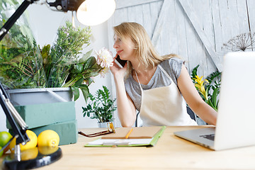 Image showing Blond florist talking on phone