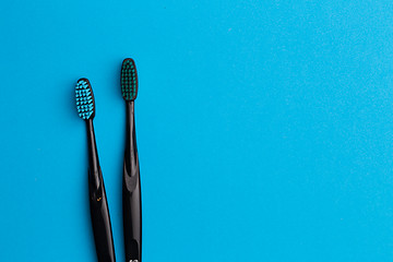 Image showing Photo of two black toothbrushes