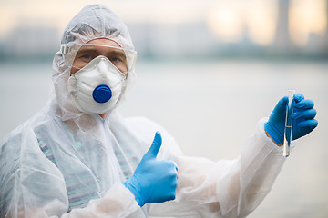 Image showing Chemist in respirator with test-tube