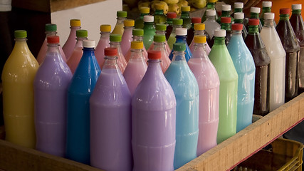 Image showing Bottles with colorful drinks. shallow dof