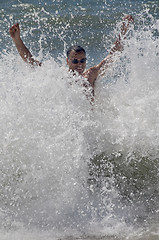 Image showing Man standing in the waves of the sea