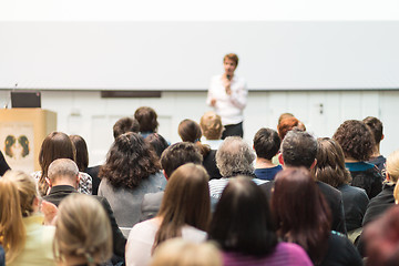 Image showing Woman giving presentation in lecture hall at university.