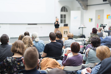 Image showing Woman giving presentation in lecture hall at university.