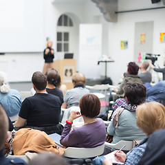 Image showing Woman giving presentation in lecture hall at university.