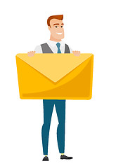 Image showing Smiling businessman holding a big envelope.