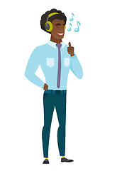 Image showing Businessman listening to music in headphones.