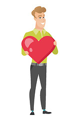 Image showing Caucasian business man holding a big red heart.