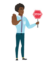 Image showing Caucasian businessman holding stop road sign.