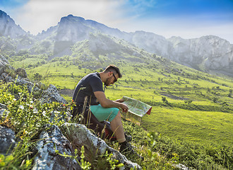 Image showing The Hiker with a Map in Misty Mountains