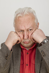 Image showing Elderly person puts his face in his hands