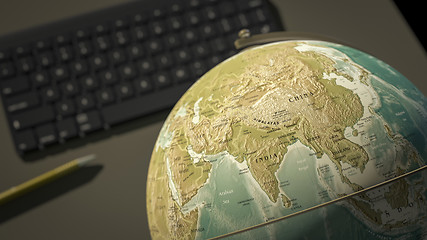 Image showing globe on a desktop shows India