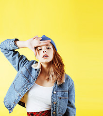 Image showing lifestyle people concept: pretty young school teenage girl having fun happy smiling on yellow background 