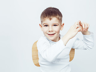 Image showing young pretty little cute boy kid wondering, posing emotional face isolated on white background, gesture happy smiling close up, lifestyle real people concept