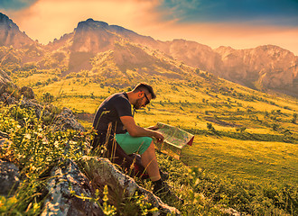 Image showing The Hiker with a Map in Misty Mountains