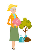 Image showing Senior caucasian farmer holding a piggy bank.