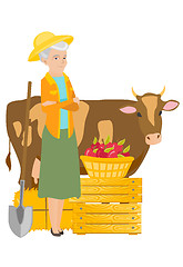 Image showing Senior farmer standing with crossed arms near cow.