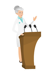 Image showing Caucasian doctor giving a speech from tribune.