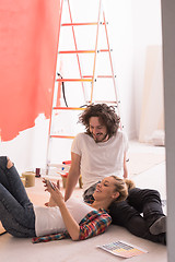 Image showing Happy young couple relaxing after painting