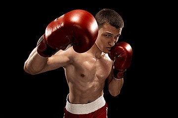 Image showing Male boxer boxing with dramatic edgy lighting in a dark studio